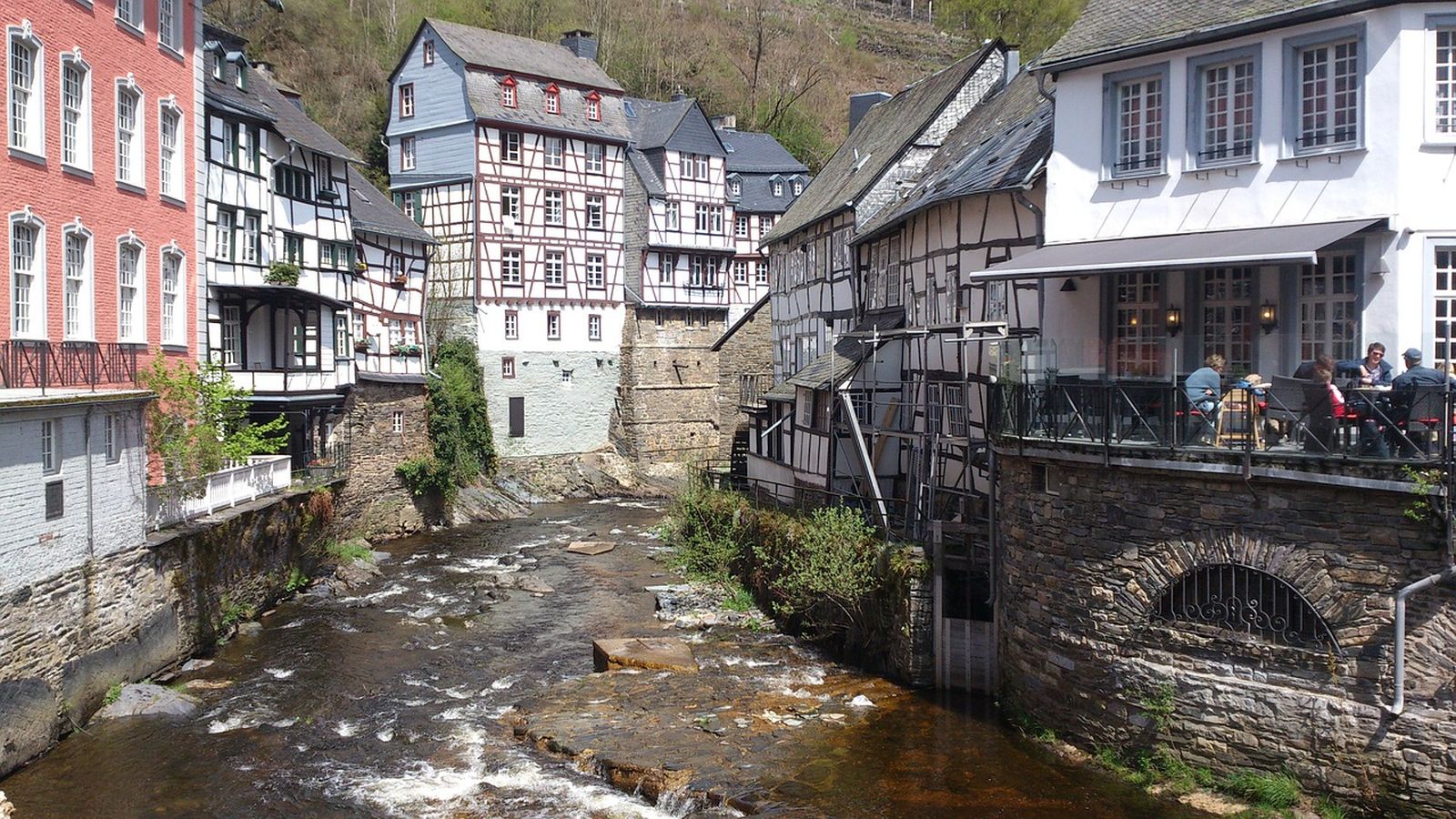 Fachwerkhäuser in einem Dorf mitten am kleinen Flusslauf in der Eifel